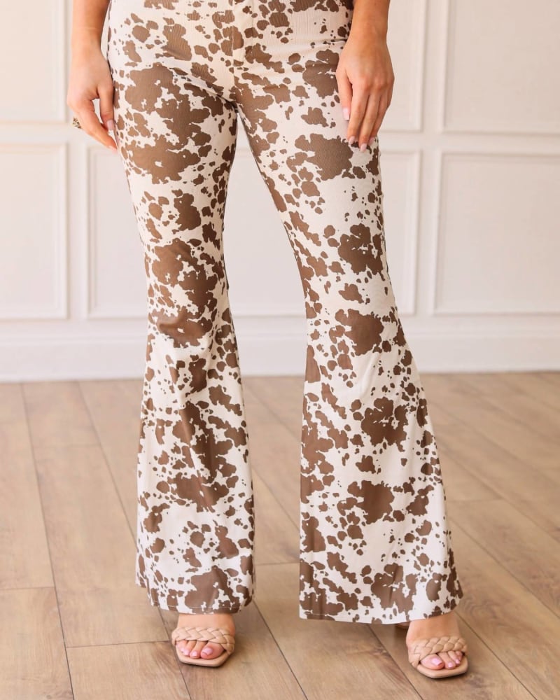 Front of a model wearing a size 3XL Free And Wild Pants in Cow in Cow by Southern Grace. | dia_product_style_image_id:339096